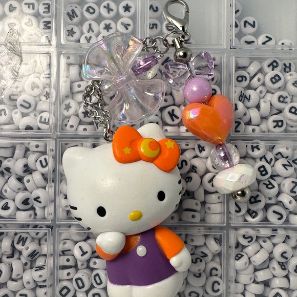 Cute Hello Kitty Character Keychains with Purple and Orange Accents - Picture 4 of 7
